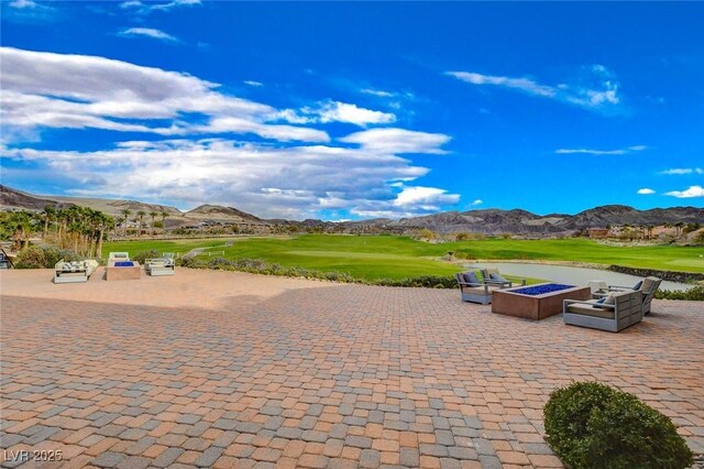 40 Strada Moscato, Henderson, NV 89011 - view of home's community with a mountain view, a patio, golf course view, and an outdoor living space with a fire pit