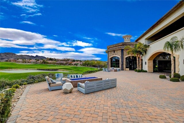 40 Strada Moscato, Henderson, NV 89011 - view of patio / terrace with view of golf course, a water and mountain view, and an outdoor living space with a fire pit