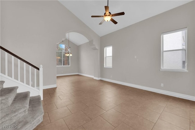 2257 Norway Pine Ct, Las Vegas, NV 89134 - unfurnished living room featuring ceiling fan, stairs, tile patterned floors, baseboards, and high vaulted ceiling