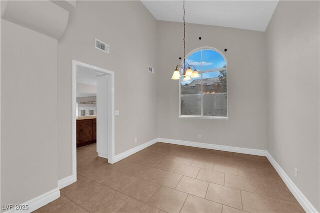 2257 Norway Pine Ct, Las Vegas, NV 89134 - unfurnished dining area featuring tile patterned flooring, baseboards, a chandelier, and high vaulted ceiling