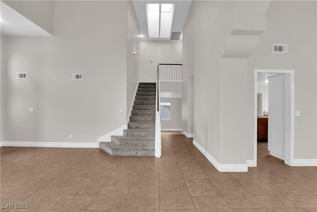 2257 Norway Pine Ct, Las Vegas, NV 89134 - stairs featuring a towering ceiling, tile patterned floors, and baseboards