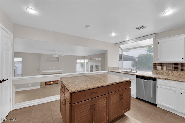2257 Norway Pine Ct, Las Vegas, NV 89134 - kitchen featuring dishwasher, a sink, white cabinets, light tile patterned floors, and recessed lighting
