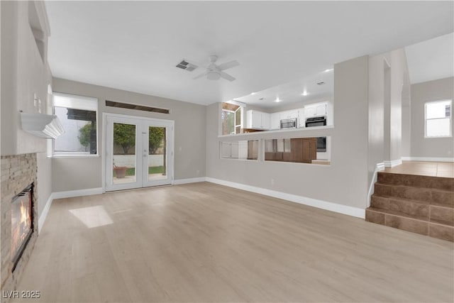 2257 Norway Pine Ct, Las Vegas, NV 89134 - unfurnished living room featuring ceiling fan, a glass covered fireplace, light wood-type flooring, baseboards, and recessed lighting