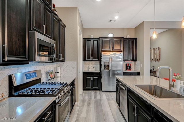 468 Harvest Rain, Las Vegas, NV 89011 - kitchen with stainless steel appliances, a sink, decorative light fixtures, light countertops, and decorative backsplash