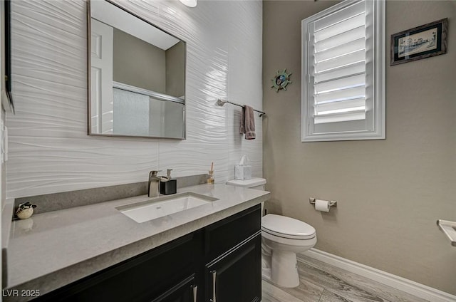 468 Harvest Rain, Las Vegas, NV 89011 - full bathroom with toilet, vanity, baseboards, an enclosed shower, and wood finished floors