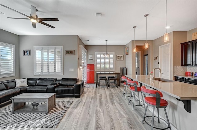 468 Harvest Rain, Las Vegas, NV 89011 - living room featuring light wood finished floors, ceiling fan, and a chandelier
