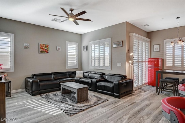 468 Harvest Rain, Las Vegas, NV 89011 - living room with light wood finished floors, a ceiling fan, a chandelier, and baseboards