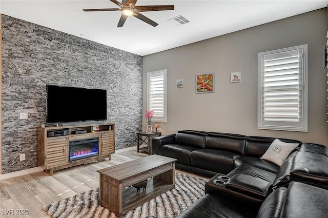 468 Harvest Rain, Las Vegas, NV 89011 - living area featuring ceiling fan, light wood-type flooring, and a glass covered fireplace