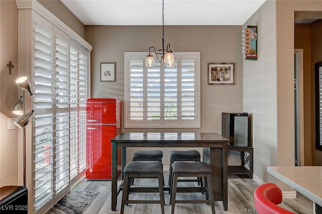 468 Harvest Rain, Las Vegas, NV 89011 - dining area featuring wood finished floors, a chandelier, and baseboards