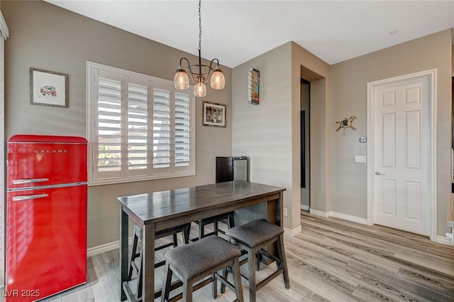 468 Harvest Rain, Las Vegas, NV 89011 - dining room featuring wood finished floors, baseboards, and a chandelier