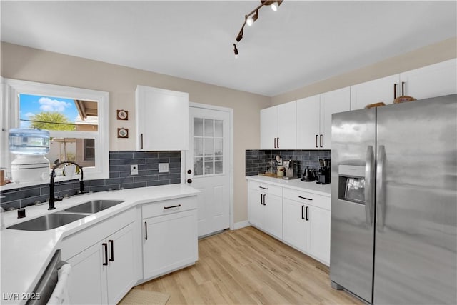 1320 Wengert Ave, Las Vegas, NV 89104 - kitchen featuring stainless steel appliances, a sink, decorative backsplash, light countertops, and white cabinetry