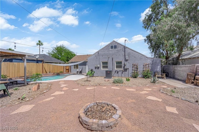 1320 Wengert Ave, Las Vegas, NV 89104 - back of property featuring a patio, a fenced backyard, central air condition unit, and stucco siding