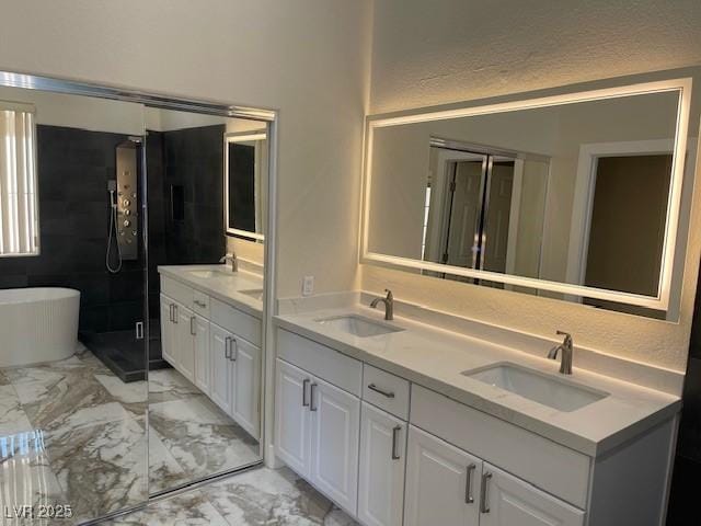 8847 W Katie Ave, Las Vegas, NV 89147 - bathroom featuring double vanity, a freestanding tub, and marble finish floors