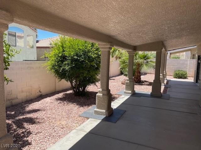 8847 W Katie Ave, Las Vegas, NV 89147 - fenced backyard with a patio