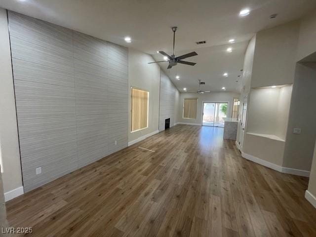 8847 W Katie Ave, Las Vegas, NV 89147 - unfurnished living room featuring a ceiling fan, wood finished floors, baseboards, high vaulted ceiling, and recessed lighting