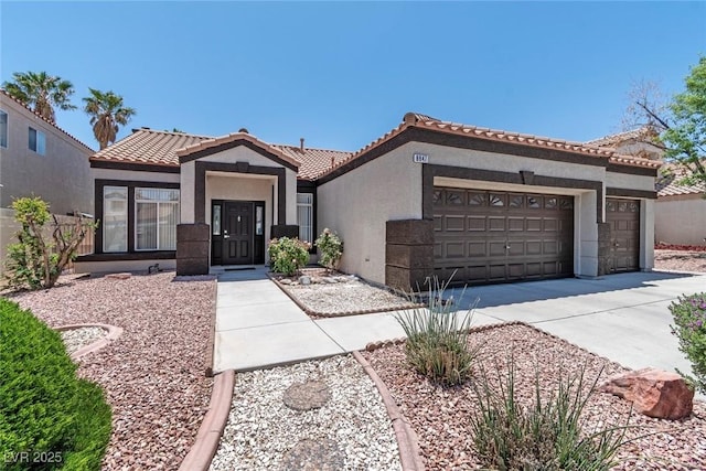 8847 W Katie Ave, Las Vegas, NV 89147 - view of front facade featuring a garage, stucco siding, concrete driveway, and a tiled roof