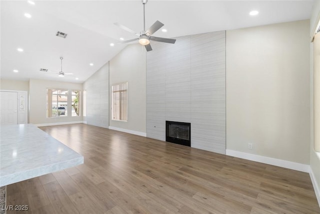 8847 W Katie Ave, Las Vegas, NV 89147 - unfurnished living room with ceiling fan, high vaulted ceiling, baseboards, a large fireplace, and recessed lighting