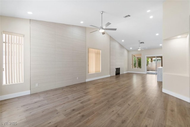 8847 W Katie Ave, Las Vegas, NV 89147 - unfurnished living room with ceiling fan, recessed lighting, high vaulted ceiling, light wood finished floors, and baseboards
