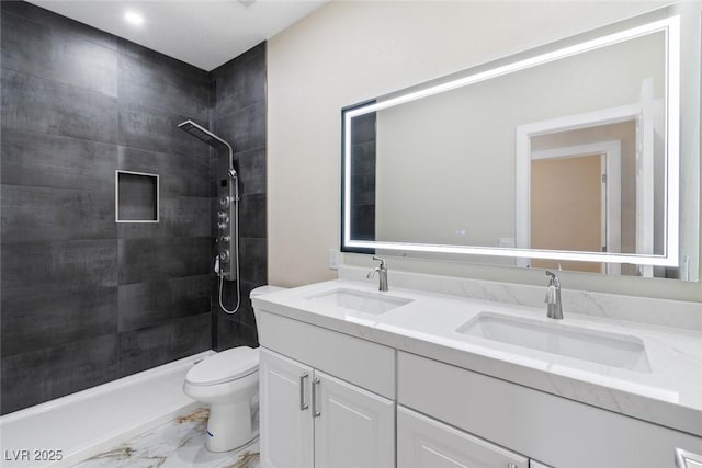 8847 W Katie Ave, Las Vegas, NV 89147 - full bathroom featuring double vanity, toilet, a tile shower, and marble look tile flooring