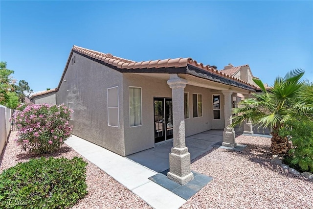 8847 W Katie Ave, Las Vegas, NV 89147 - view of home's exterior featuring stucco siding, a patio area, and a tile roof