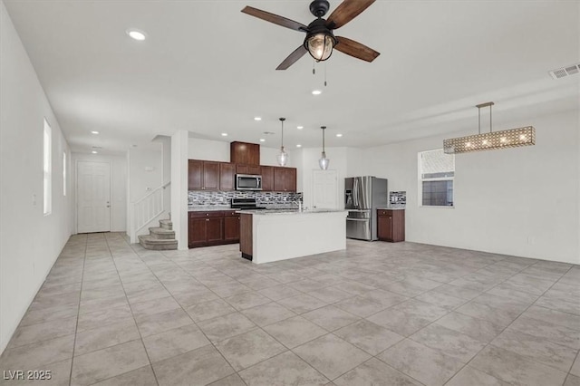 9198 Harbin Ave, Las Vegas, NV 89148 - kitchen featuring appliances with stainless steel finishes, backsplash, a ceiling fan, light countertops, and open floor plan