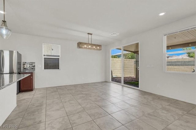 9198 Harbin Ave, Las Vegas, NV 89148 - unfurnished dining area with plenty of natural light, light tile patterned flooring, and recessed lighting