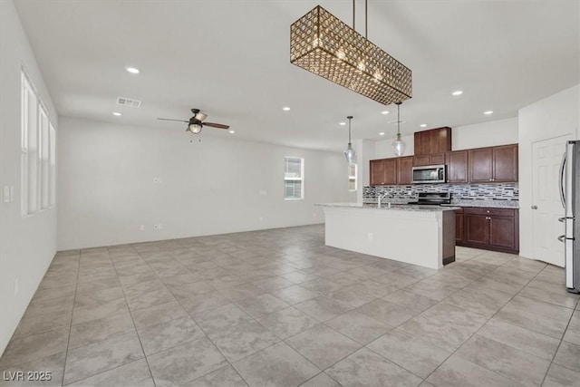 9198 Harbin Ave, Las Vegas, NV 89148 - kitchen with appliances with stainless steel finishes, recessed lighting, decorative backsplash, open floor plan, and ceiling fan