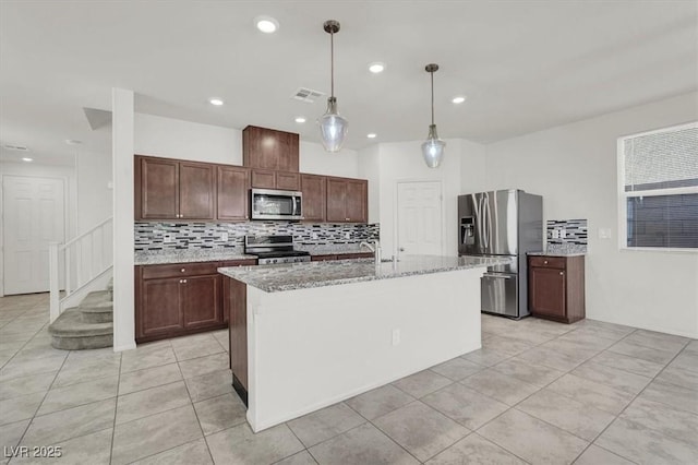 9198 Harbin Ave, Las Vegas, NV 89148 - kitchen featuring appliances with stainless steel finishes, decorative backsplash, light tile patterned flooring, light stone counters, and pendant lighting