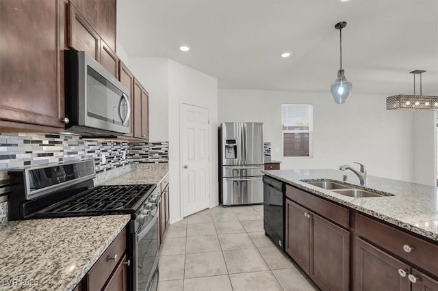 9198 Harbin Ave, Las Vegas, NV 89148 - kitchen with stainless steel appliances, a sink, decorative backsplash, decorative light fixtures, and light tile patterned floors
