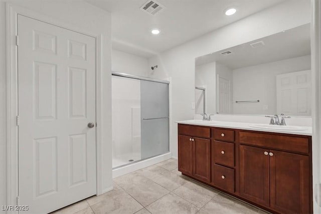 9198 Harbin Ave, Las Vegas, NV 89148 - bathroom featuring a stall shower, tile patterned flooring, double vanity, and recessed lighting