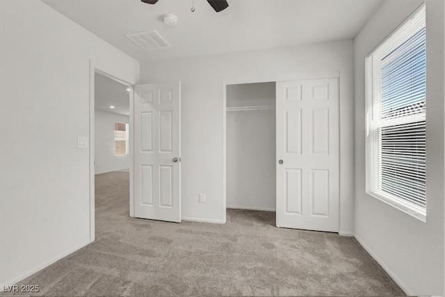 9198 Harbin Ave, Las Vegas, NV 89148 - unfurnished bedroom featuring carpet, multiple windows, a closet, and a ceiling fan