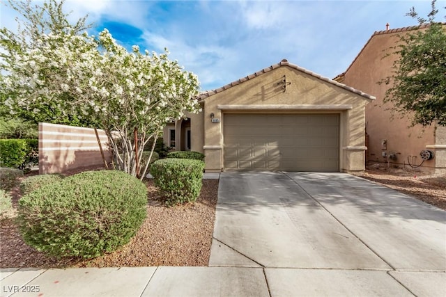 3005 Dotted Wren Ave, North Las Vegas, NV 89084 - view of front of house featuring concrete driveway, an attached garage, stucco siding, and a tiled roof