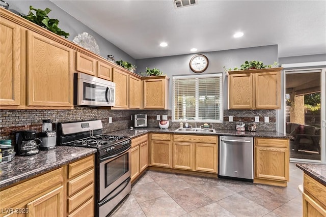 3005 Dotted Wren Ave, North Las Vegas, NV 89084 - kitchen with stainless steel appliances, a sink, backsplash, recessed lighting, and light tile patterned floors