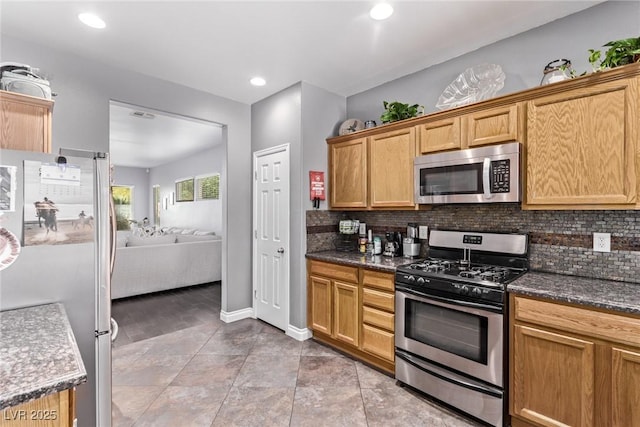 3005 Dotted Wren Ave, North Las Vegas, NV 89084 - kitchen with stainless steel appliances, decorative backsplash, recessed lighting, open floor plan, and dark stone counters