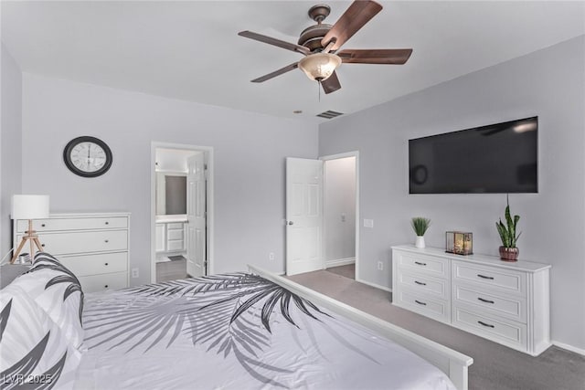 3005 Dotted Wren Ave, North Las Vegas, NV 89084 - bedroom featuring dark carpet, baseboards, ensuite bathroom, and a ceiling fan