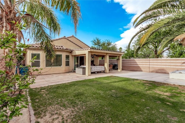 3005 Dotted Wren Ave, North Las Vegas, NV 89084 - back of property featuring a tiled roof, stucco siding, a ceiling fan, and a patio