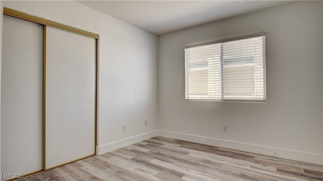 4653 Califa Dr, Las Vegas, NV 89122 - unfurnished bedroom featuring a closet, light wood-type flooring, and baseboards