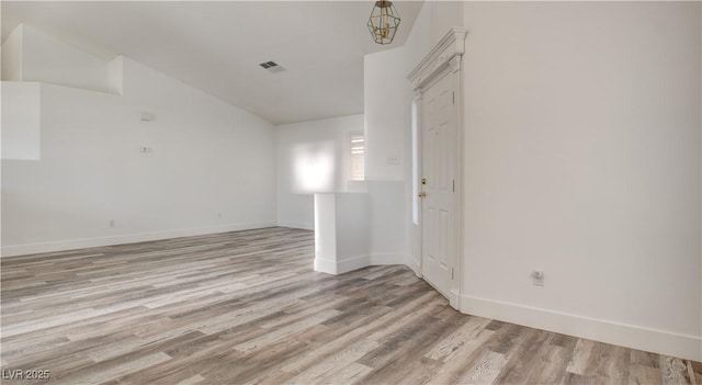 4653 Califa Dr, Las Vegas, NV 89122 - unfurnished room featuring light wood-style floors, lofted ceiling, and baseboards