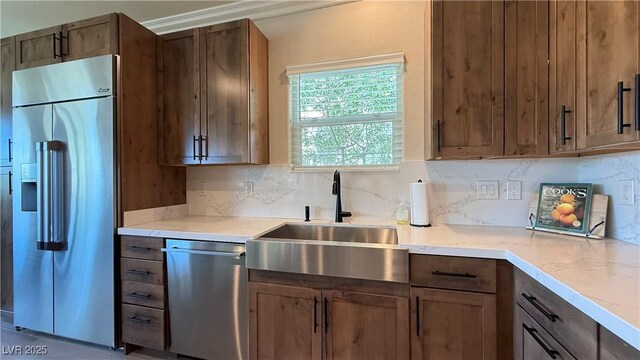 4299 Fiore Bella Blvd, Las Vegas, NV 89135 - kitchen featuring stainless steel appliances, a sink, tasteful backsplash, and light countertops