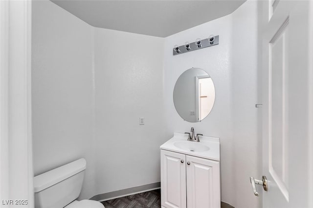 bathroom with toilet and vanity