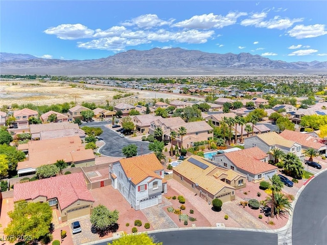 aerial view of residential area featuring mountains