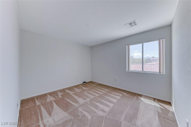 carpeted empty room with baseboards