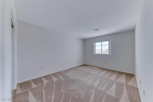 carpeted empty room with baseboards