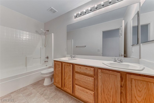 bathroom with toilet,  shower combination, double vanity, and tile patterned floors