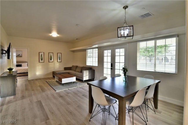 2926 E Eldorado Ln, Las Vegas, NV 89120 - dining area with a chandelier, baseboards, and light wood-style flooring