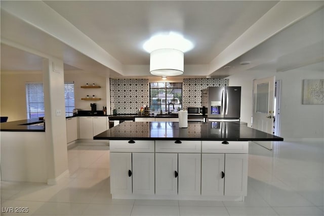 2926 E Eldorado Ln, Las Vegas, NV 89120 - kitchen featuring appliances with stainless steel finishes, dark countertops, white cabinetry, light tile patterned flooring, and backsplash