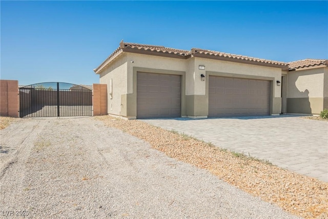 37 Late Harvest Ave, Pahrump, NV 89060 - view of front of home featuring a gate, stucco siding, an attached garage, and a tile roof