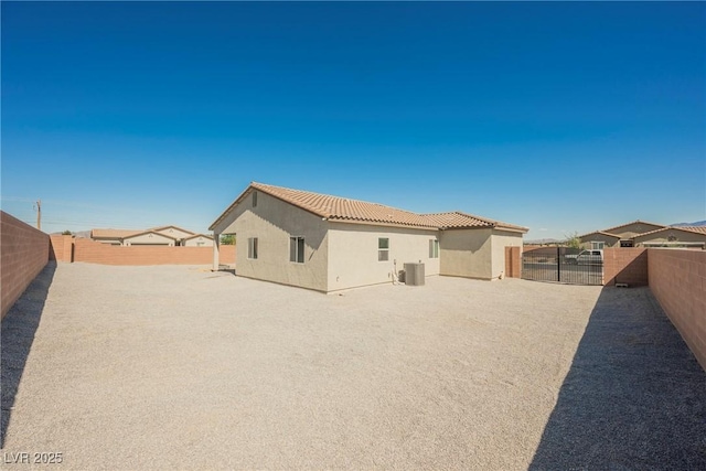 37 Late Harvest Ave, Pahrump, NV 89060 - back of property featuring stucco siding, a fenced backyard, a tile roof, and central AC unit