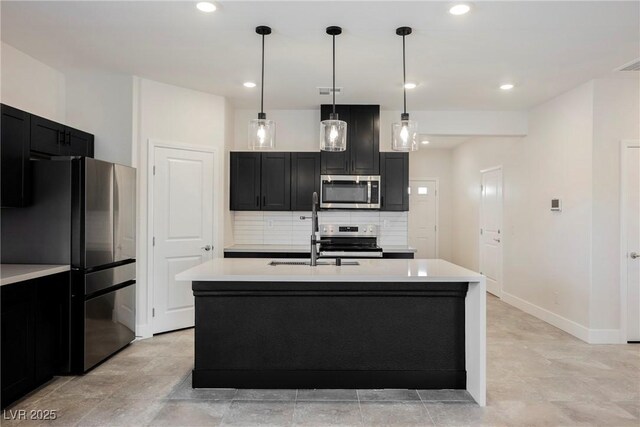 37 Late Harvest Ave, Pahrump, NV 89060 - kitchen featuring stainless steel appliances, a sink, light countertops, dark cabinetry, and recessed lighting