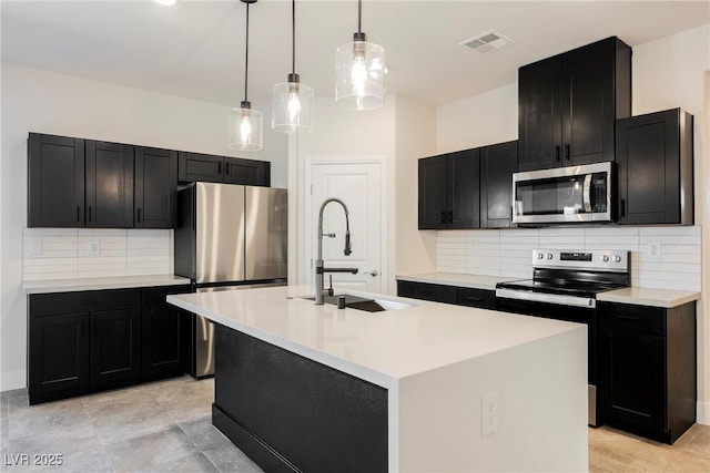 37 Late Harvest Ave, Pahrump, NV 89060 - kitchen with appliances with stainless steel finishes, a sink, dark cabinets, and backsplash